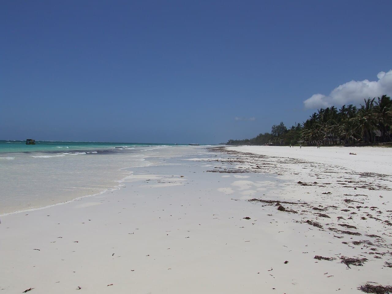 White sandy shoreline and turquoise water at Diani Beach