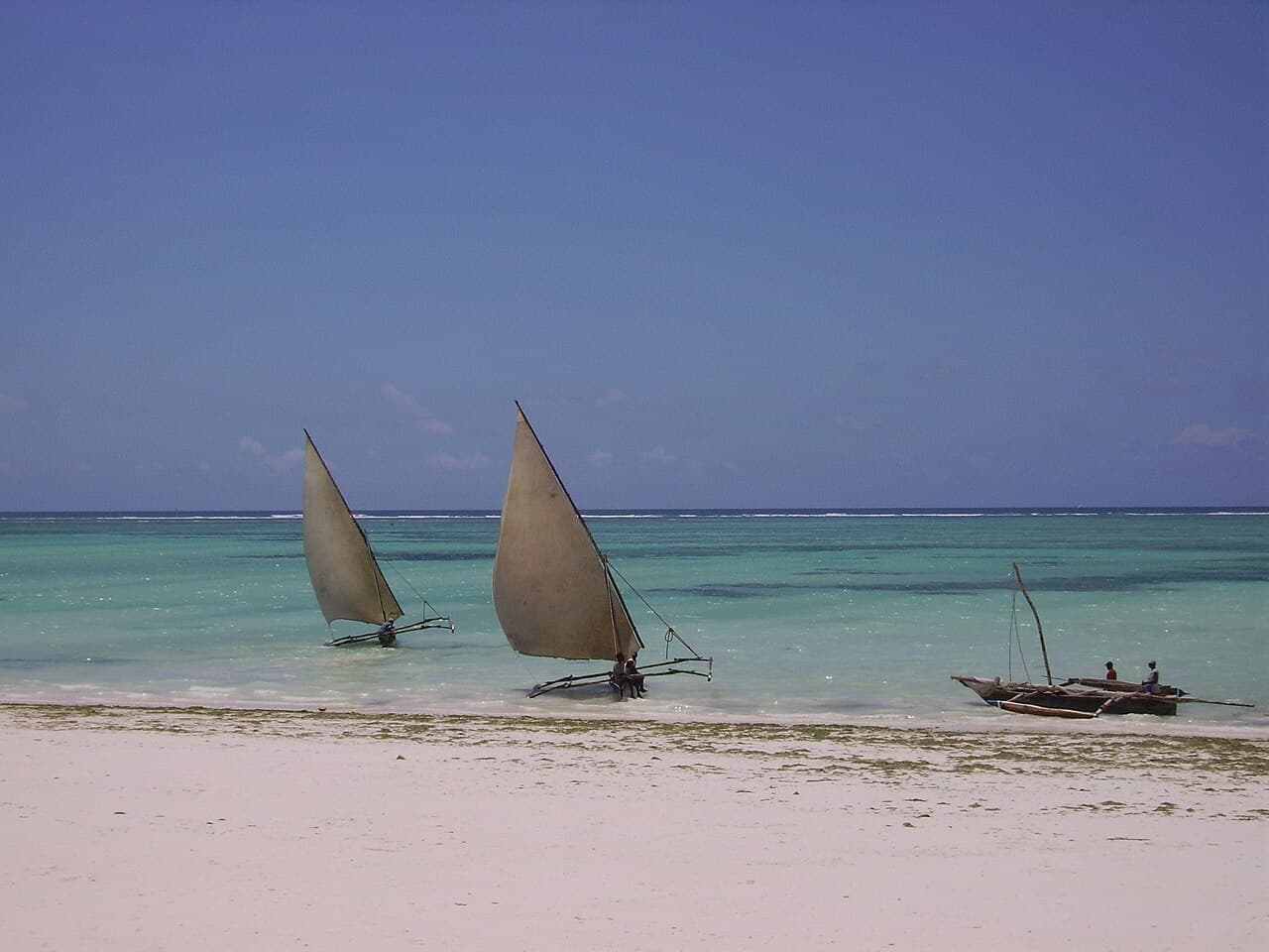 Traditional dhow boats on a white-sand Zanzibar beach